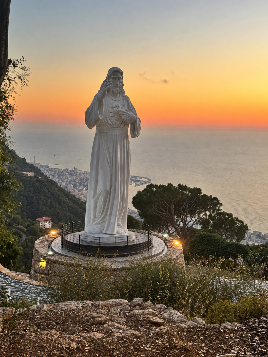 Sacred Heart statue overlooking Jounieh Bay at sunset