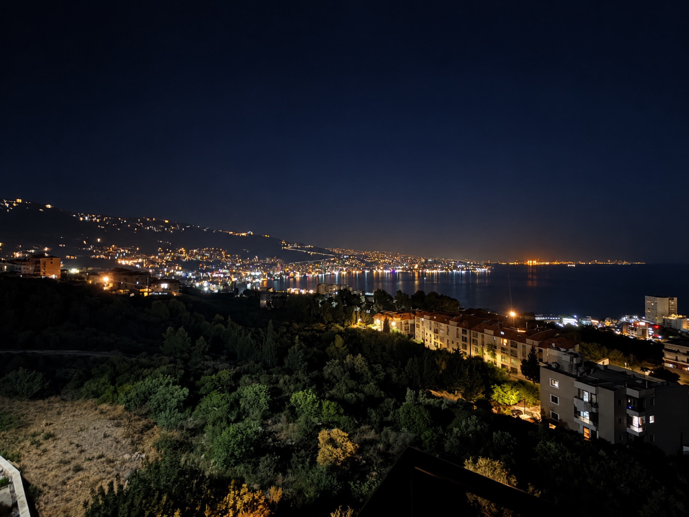 Actual nighttime view across illuminated Jounieh Bay