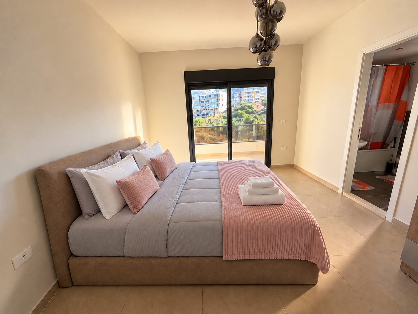 Primary king bedroom with balcony access and ensuite bathroom